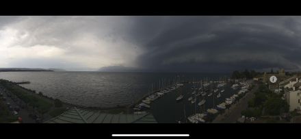 Figure 2 :  ligne de grain arquée arrivant sur Morges le 22 juin. Ce type de nuage est appelé arcus et précède le front de rafales. Source. Webcam du port de Morges.