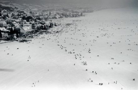 Vue aérienne de la surface gelée du lac avec de la neige et des personnes.