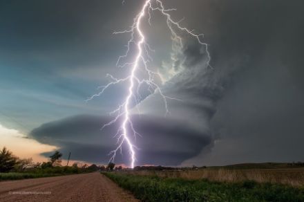  	Photo d’un nuage d’orage en rotation avec un éclair sur un paysage plat.